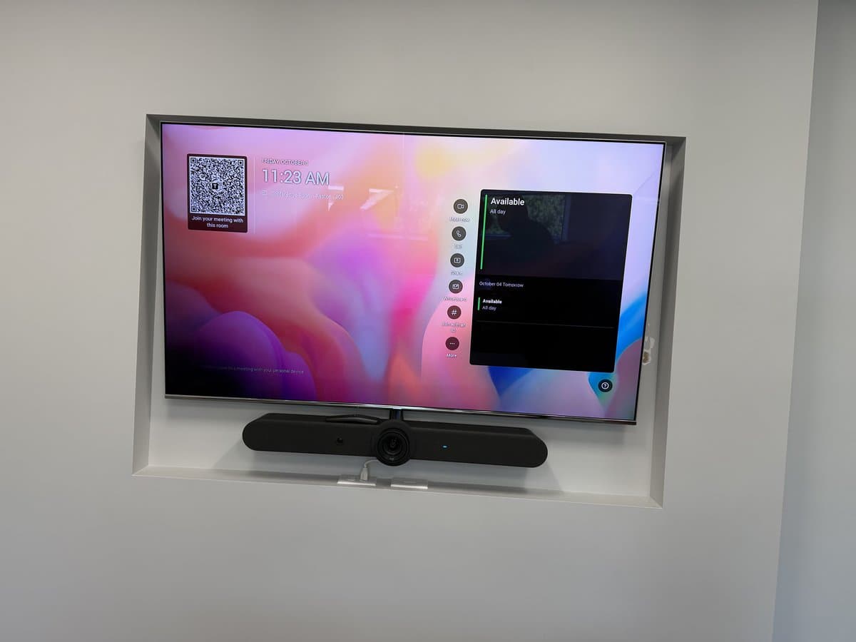 Wall-mounted display with integrated camera and soundbar for video conferencing
